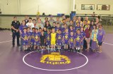 The Lemoore Lions Club, members of the Lemoore Police Department and youth involved in the Police Athletic League show off their new wrestling mat.
